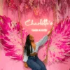 Neon wall setup with feather wings, florals and a swing for a cake and gift shop