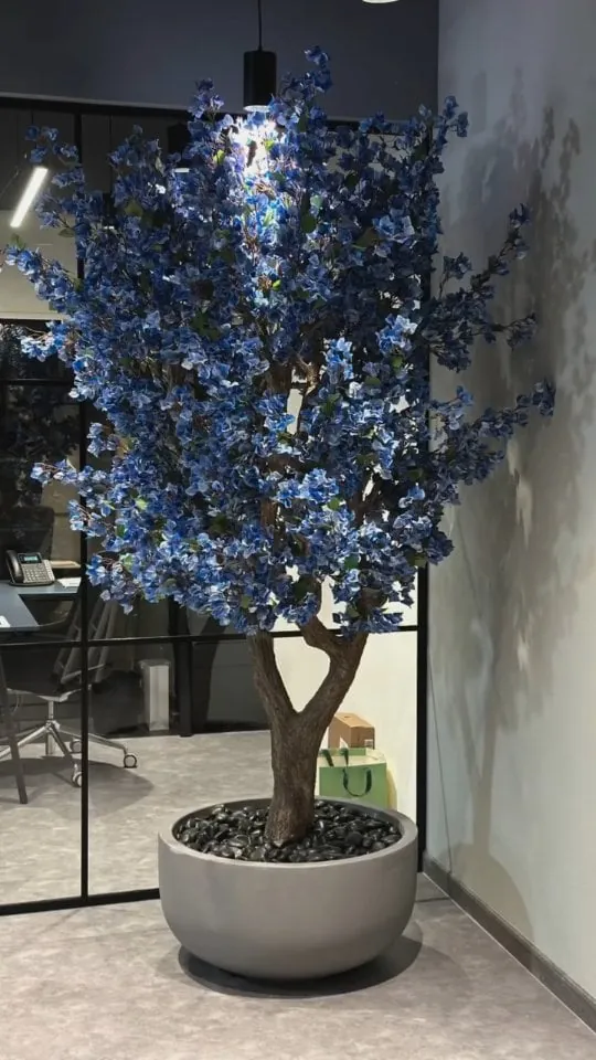 blue blossom tree on a real trunk — office corner, Lebanon — installation by Neon Jungle Studios