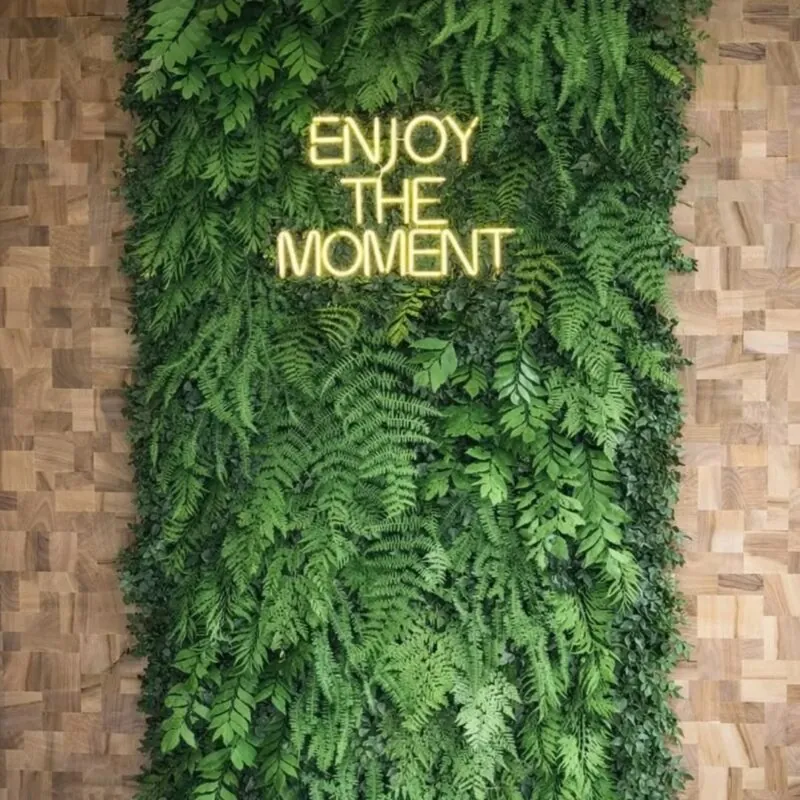 fern green wall with a neon phrase — interior corner, Lebanon — installation by Neon Jungle Studios
