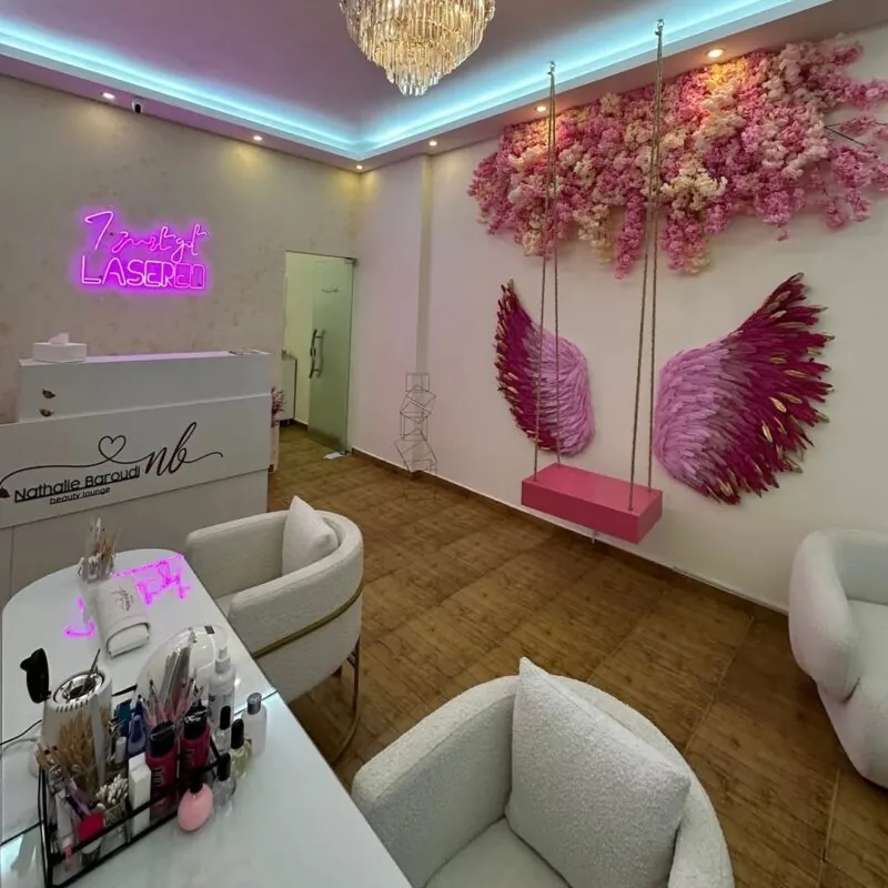 floral wings, swing and pink neon name — beauty salon, Lebanon — installation by Neon Jungle Studios