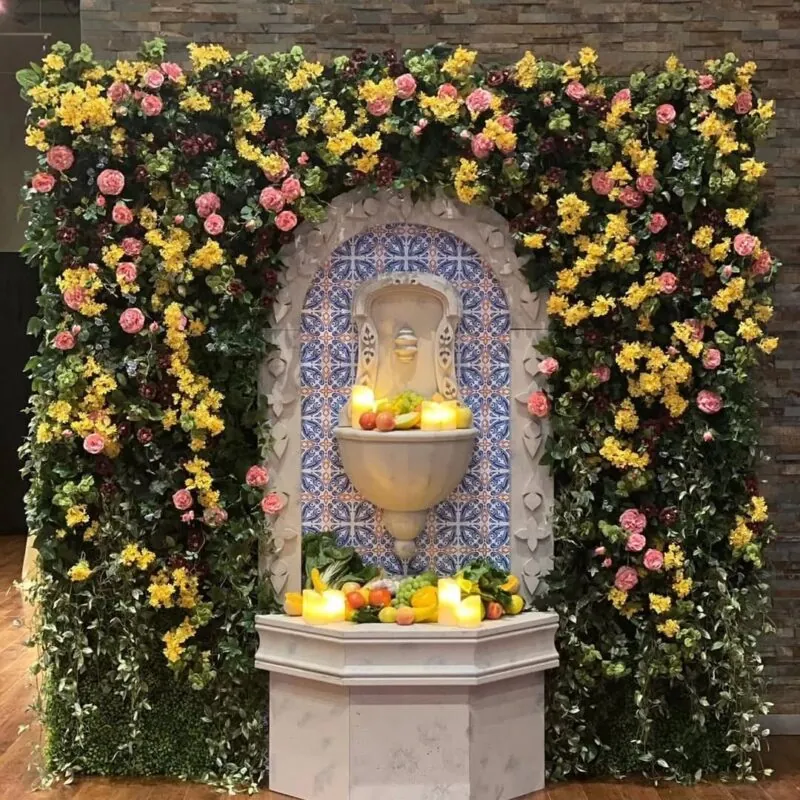 flower wall with a tiled fountain stand — event setup, Lebanon — installation by Neon Jungle Studios
