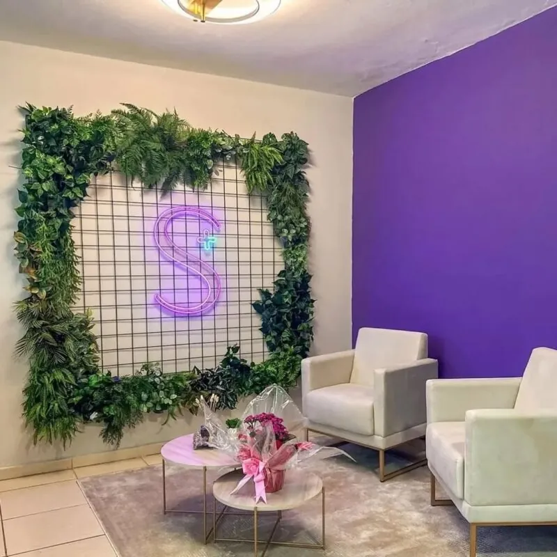 greenery frame around a purple neon letter — lounge, Lebanon — installation by Neon Jungle Studios