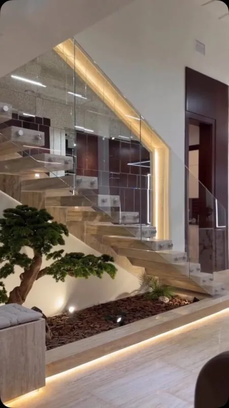 lit under-stairs bonsai garden — home under a glass staircase, Lebanon — installation by Neon Jungle Studios
