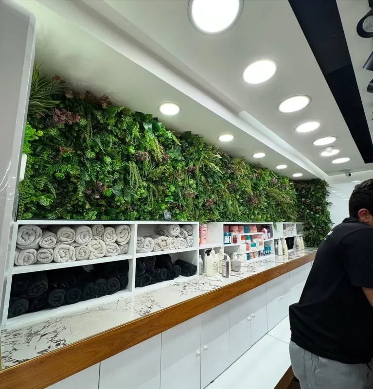 long green wall above the counter — beauty lounge, Lebanon — installation by Neon Jungle Studios
