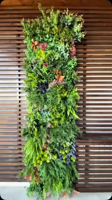 narrow vertical garden on dark slats — interior wall, Lebanon — installation by Neon Jungle Studios
