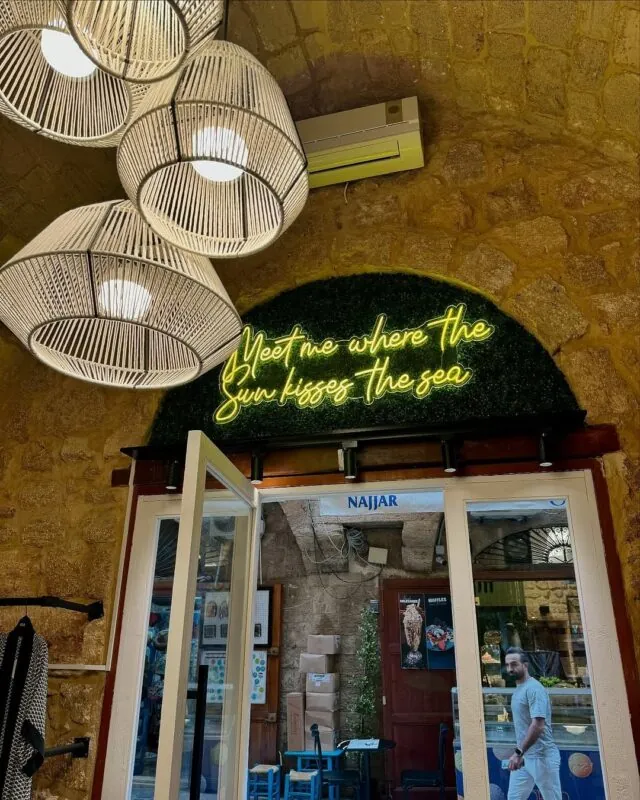 neon phrase on a greenery arch — seaside shop in Batroun, Batroun — installation by Neon Jungle Studios