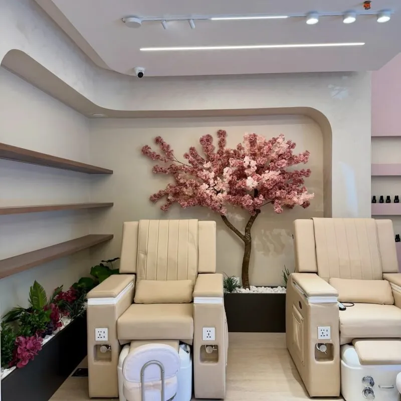 pink cherry blossom in a lit niche — nail salon pedicure area, Lebanon — installation by Neon Jungle Studios
