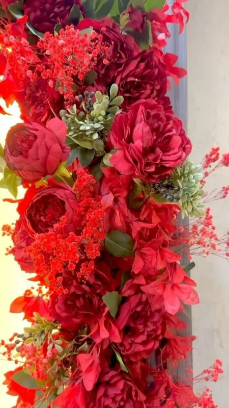 red roses and peonies framing a door — beauty centre doorway, Lebanon — installation by Neon Jungle Studios