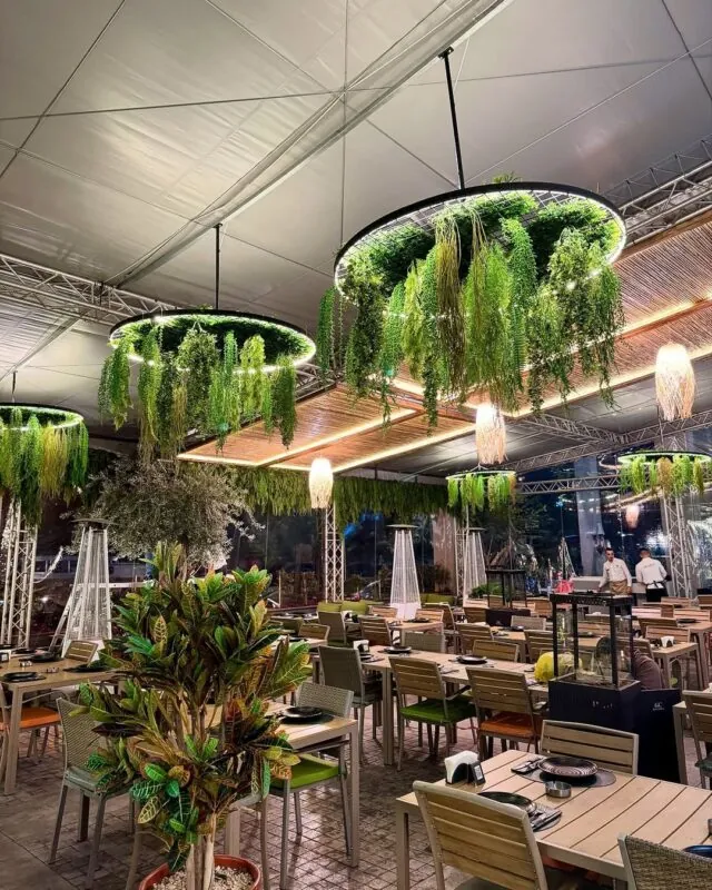 round greenery chandeliers — outdoor restaurant terrace, Lebanon — installation by Neon Jungle Studios