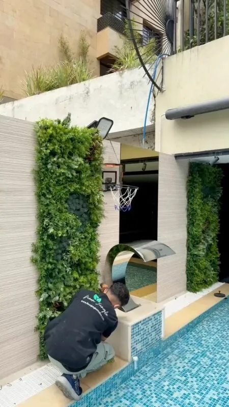 two vertical garden columns — pool with a steel waterfall, Lebanon — installation by Neon Jungle Studios