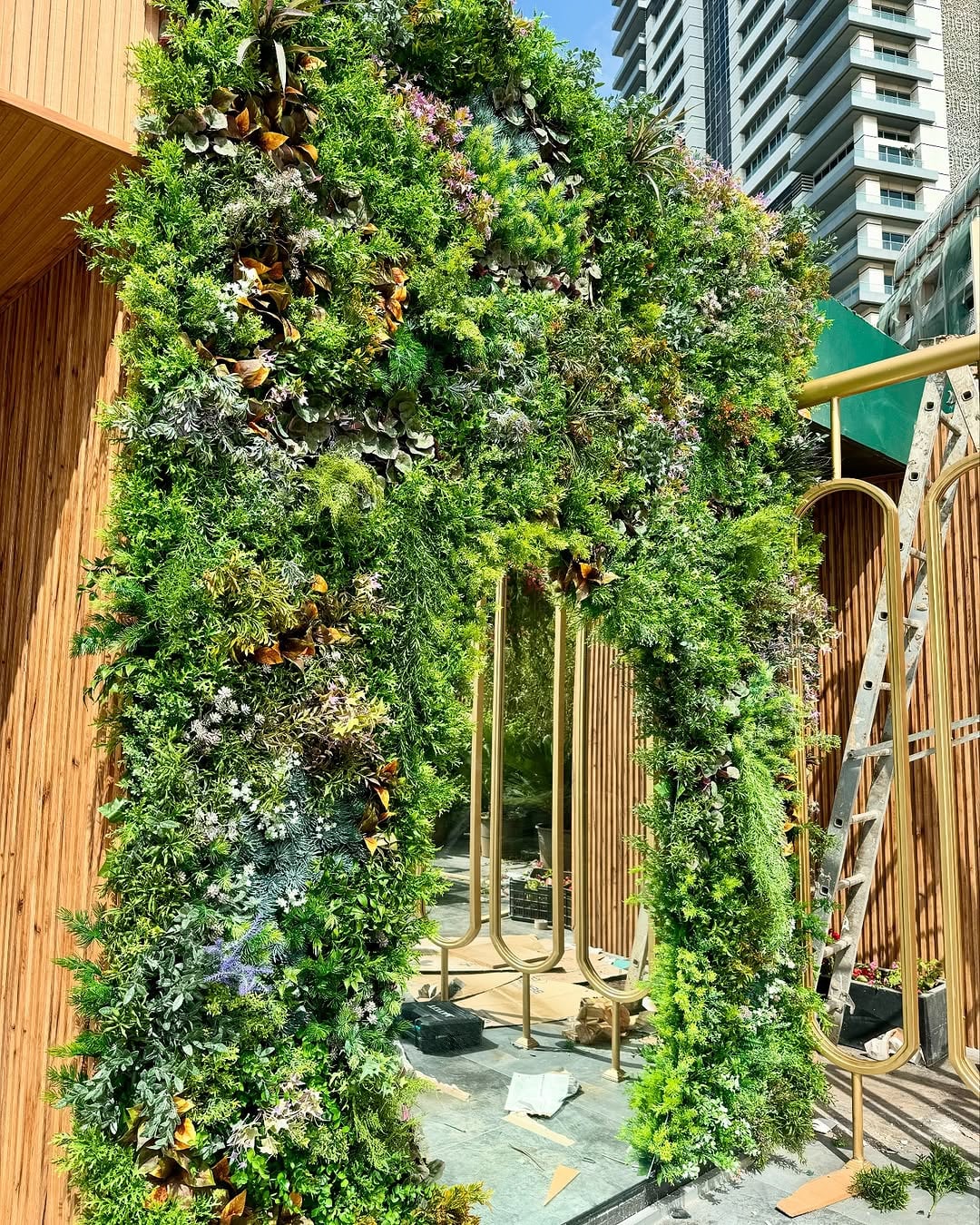 vertical garden and green arch — city rooftop lounge, Lebanon — installation by Neon Jungle Studios